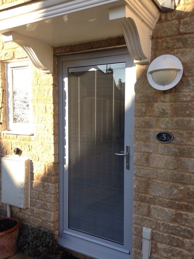 the new aluminium door now benefits from a large glass area and an integral blind for controlled privacy and light.