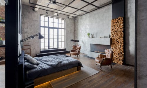 loft apartment with steel-look windows by unmade bed