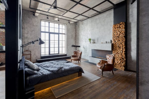 loft apartment with steel-look windows by unmade bed