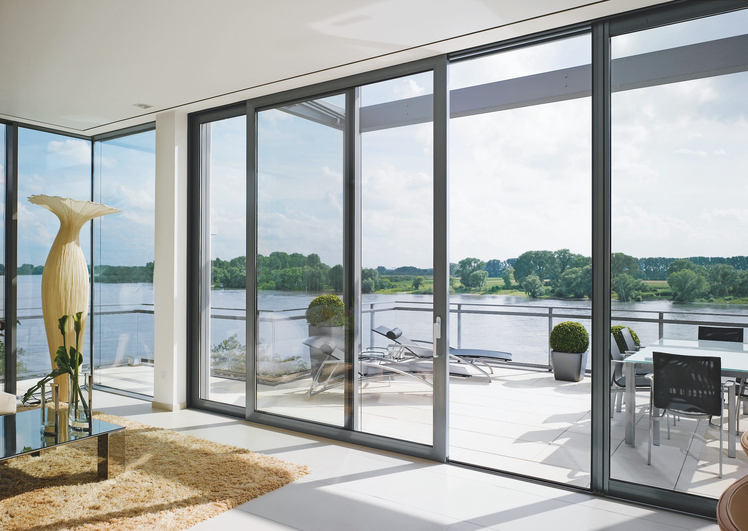 contemporary sliding patio doors overlooking a river