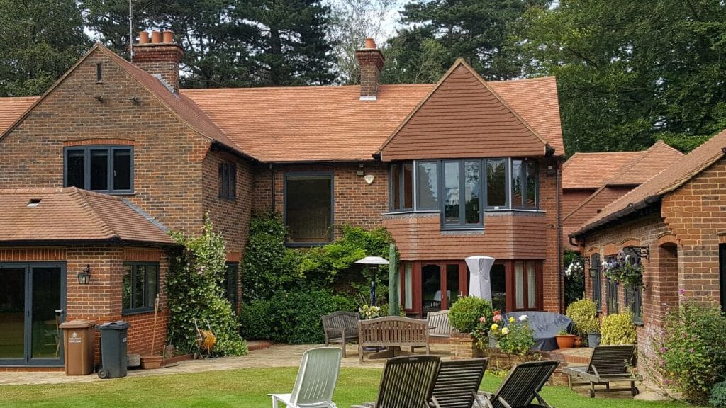 origin aluminium windows in a grey colour fitted in a large surrey house