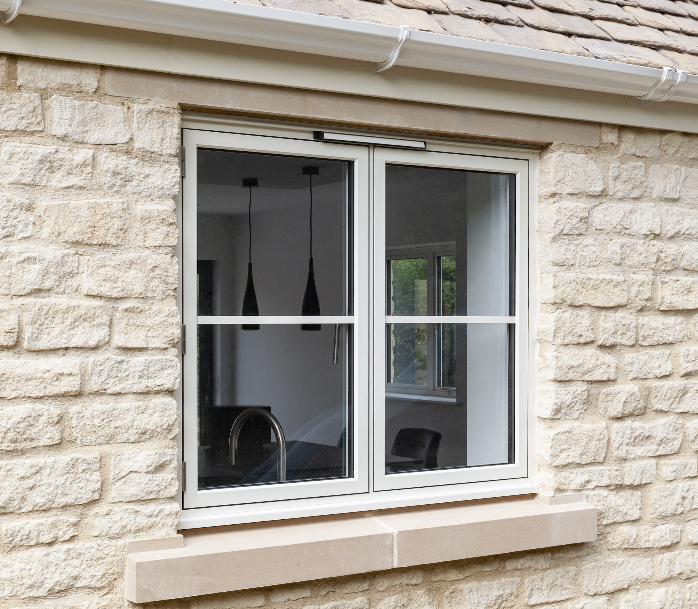 flush casement type of aluminium window in a cottage