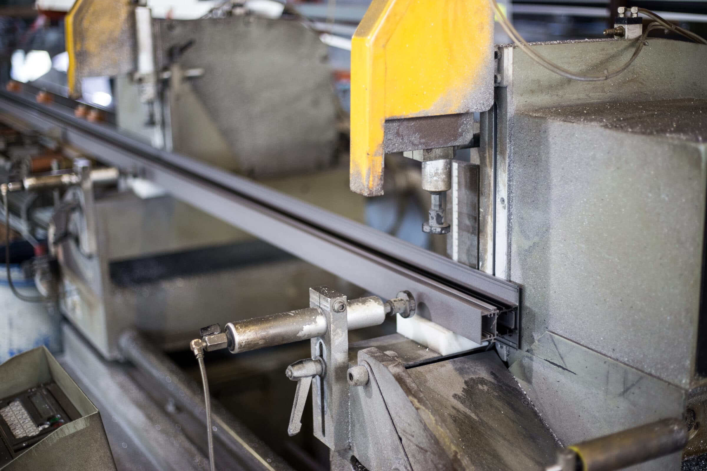 types of aluminium windows showing an aluminium bar on cutting machine