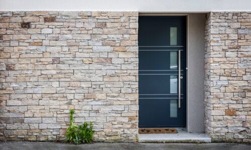 modern grey hybrid entrance door in a stone house