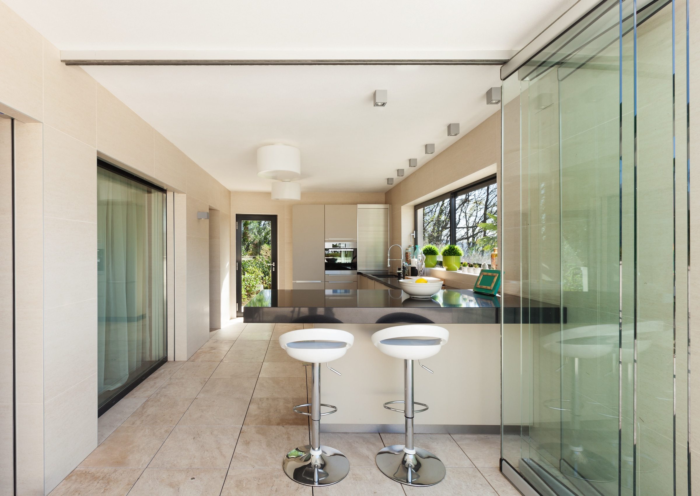 slide and turn aluminium internal doors separating a dining room and kitchen