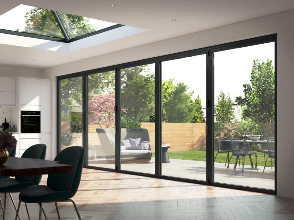 korniche bifold doors in a room setting with lantern roof above and garden views