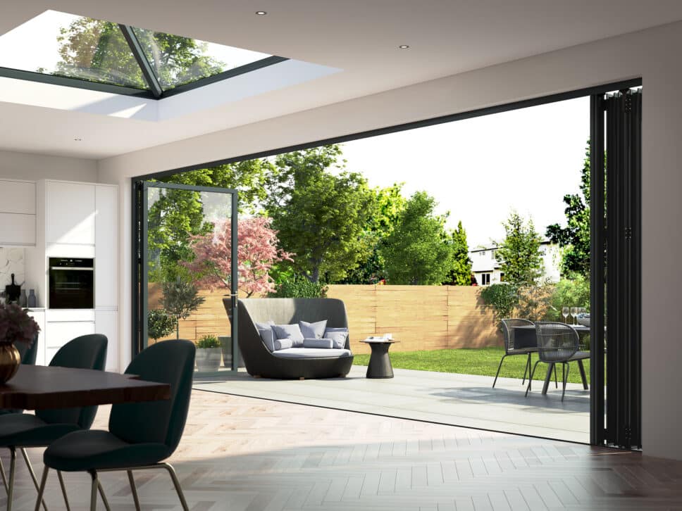 fully open black kornice bifold doors in a modern lounge leading to a patio