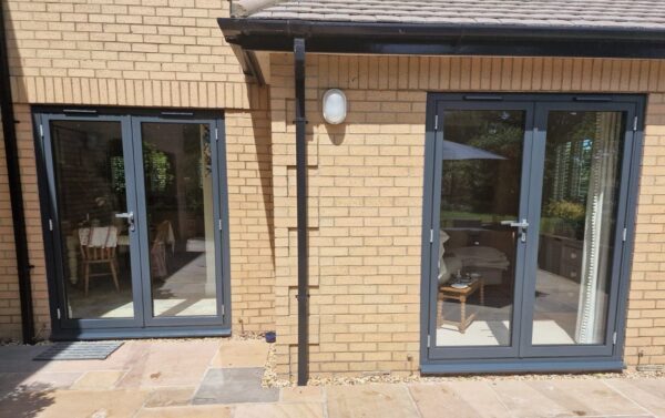 schüco grey french doors in a new brick built house