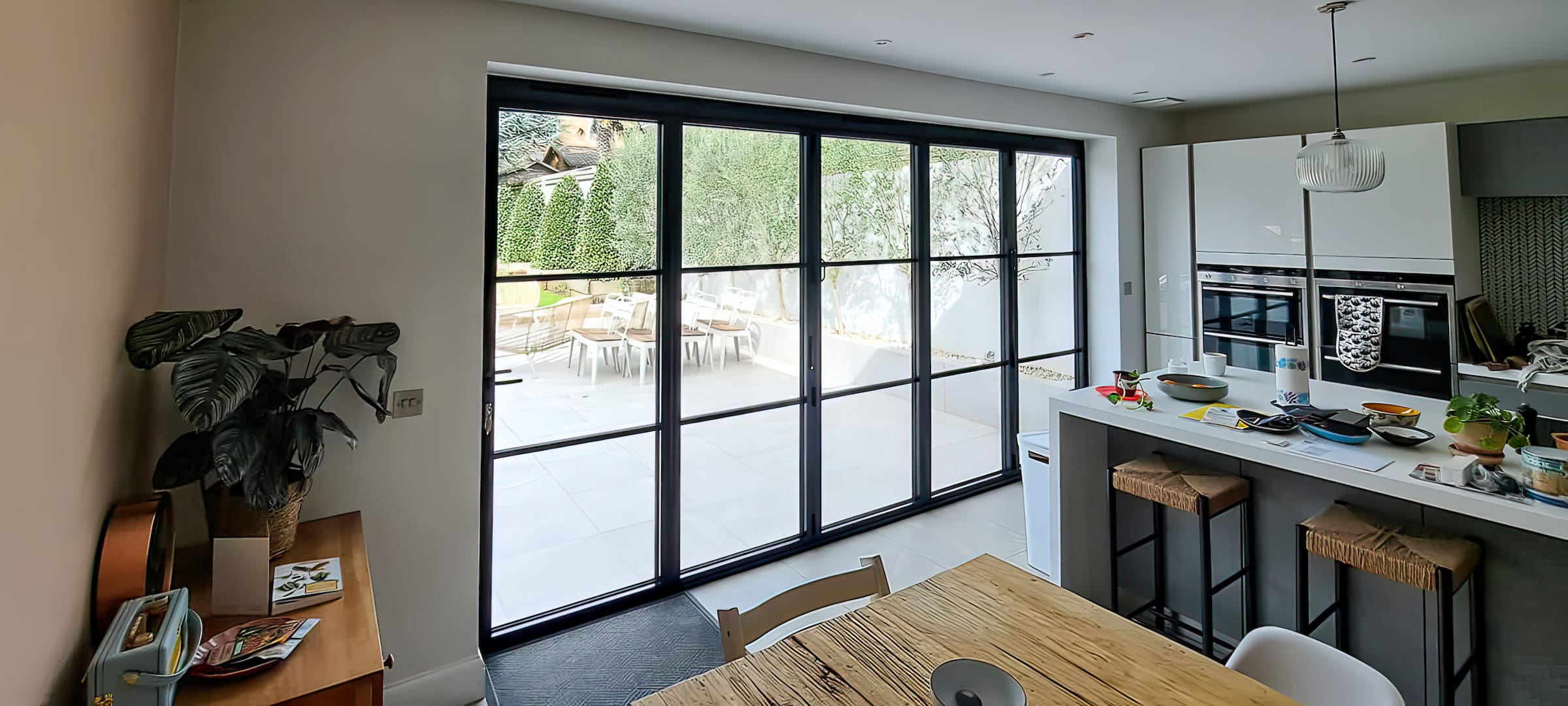 kitchen renovation with slim steel look bifold doors and patio views.