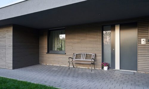 schüco ad up 90 in a brown and cream contemporary house with lawn and patio