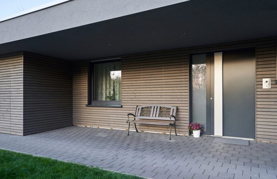 schüco ad up 90 in a brown and cream contemporary house with lawn and patio