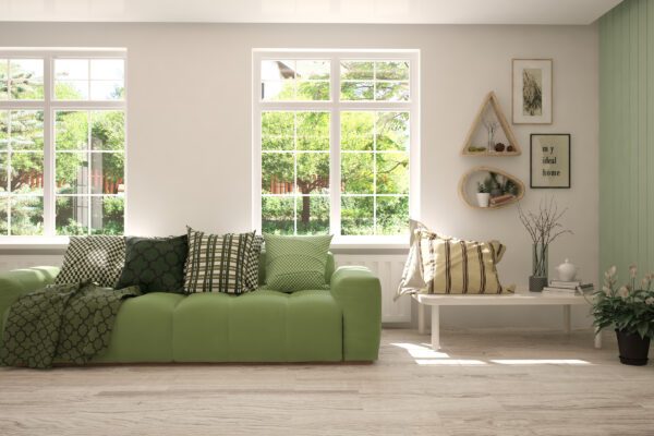 slimline aluminium windows in a modern lounge setting with green sofa